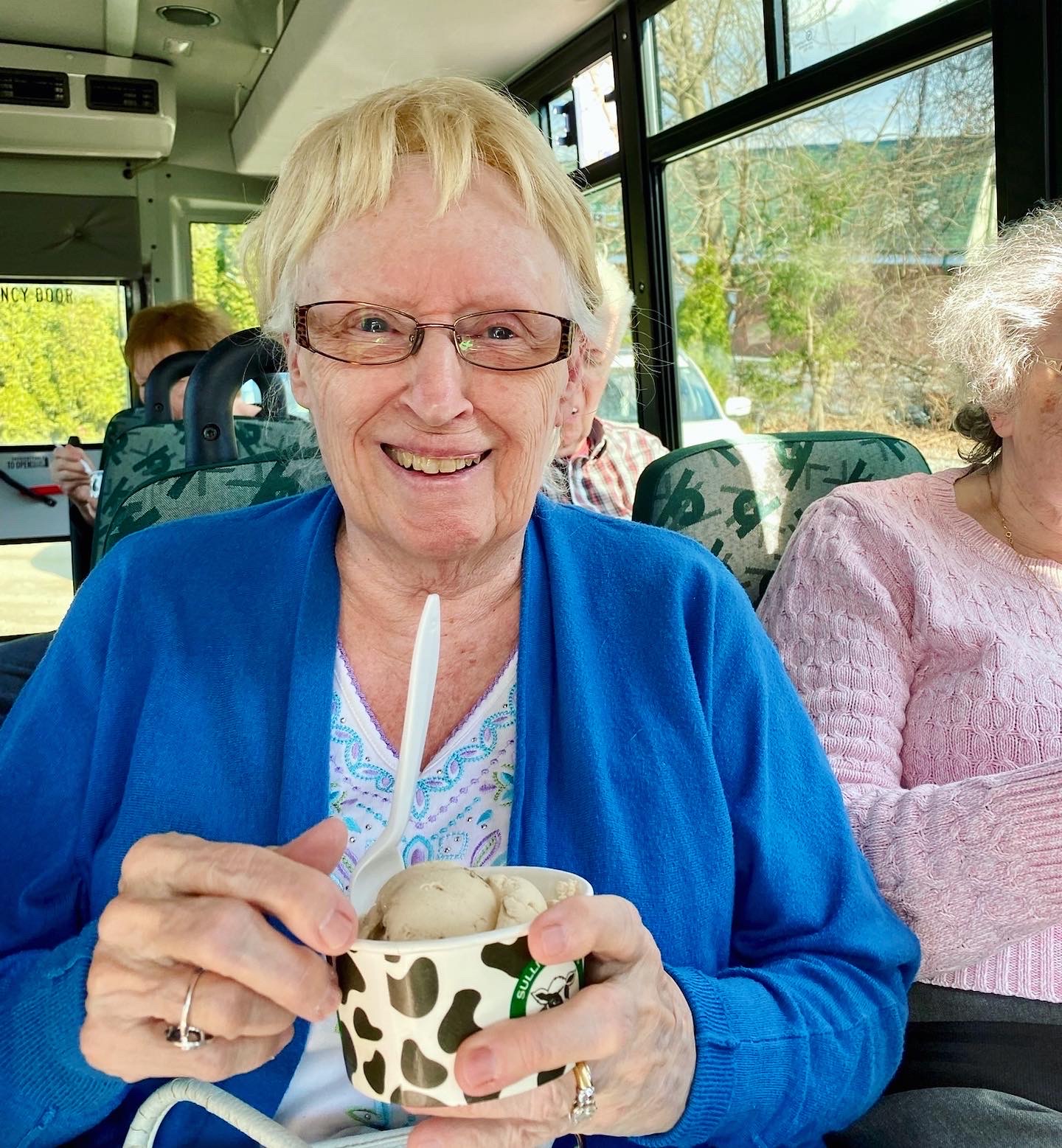 Resident enjoying ice cream on a bus outing