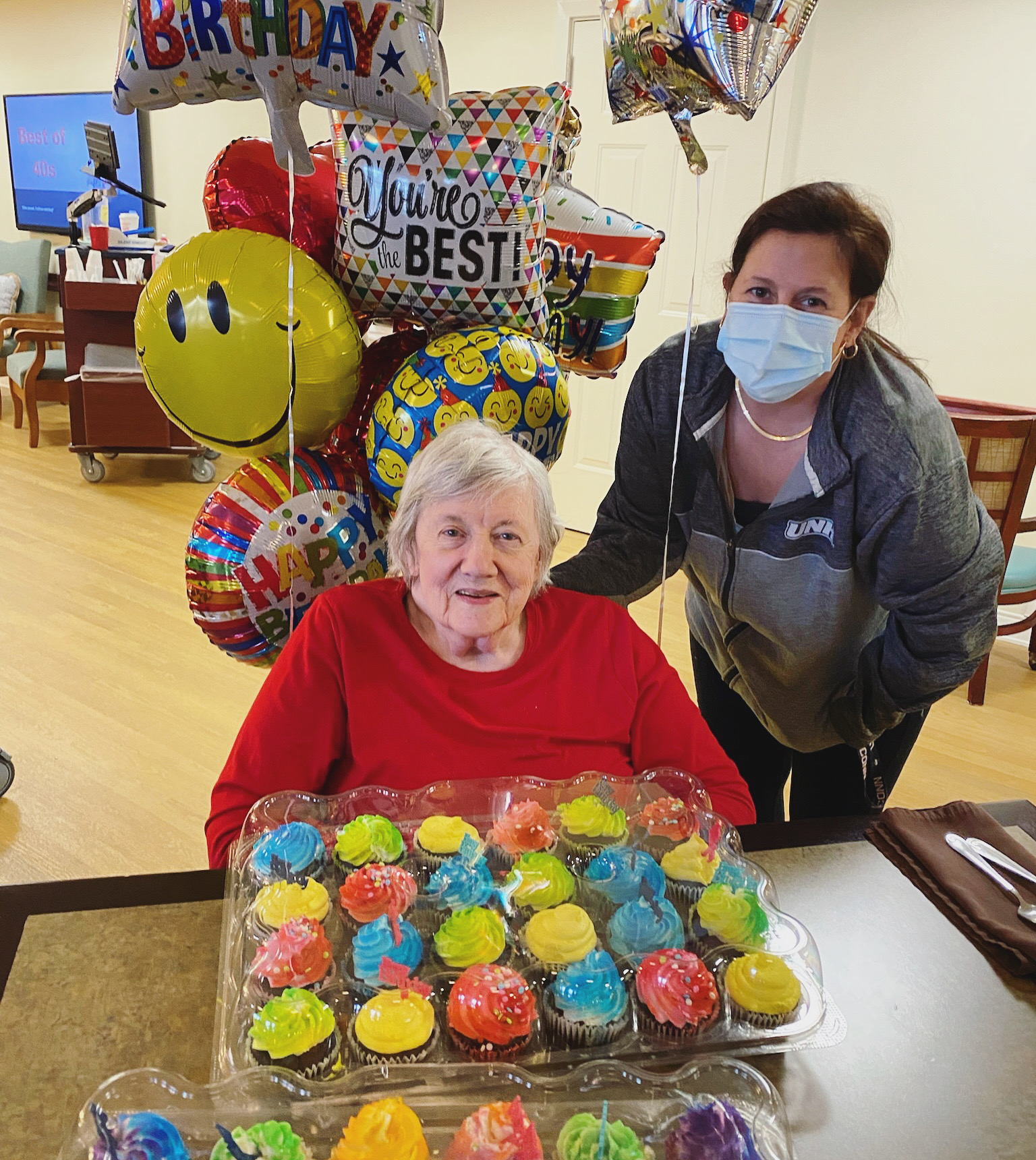 Resident celebrating with cupcakes and balloons