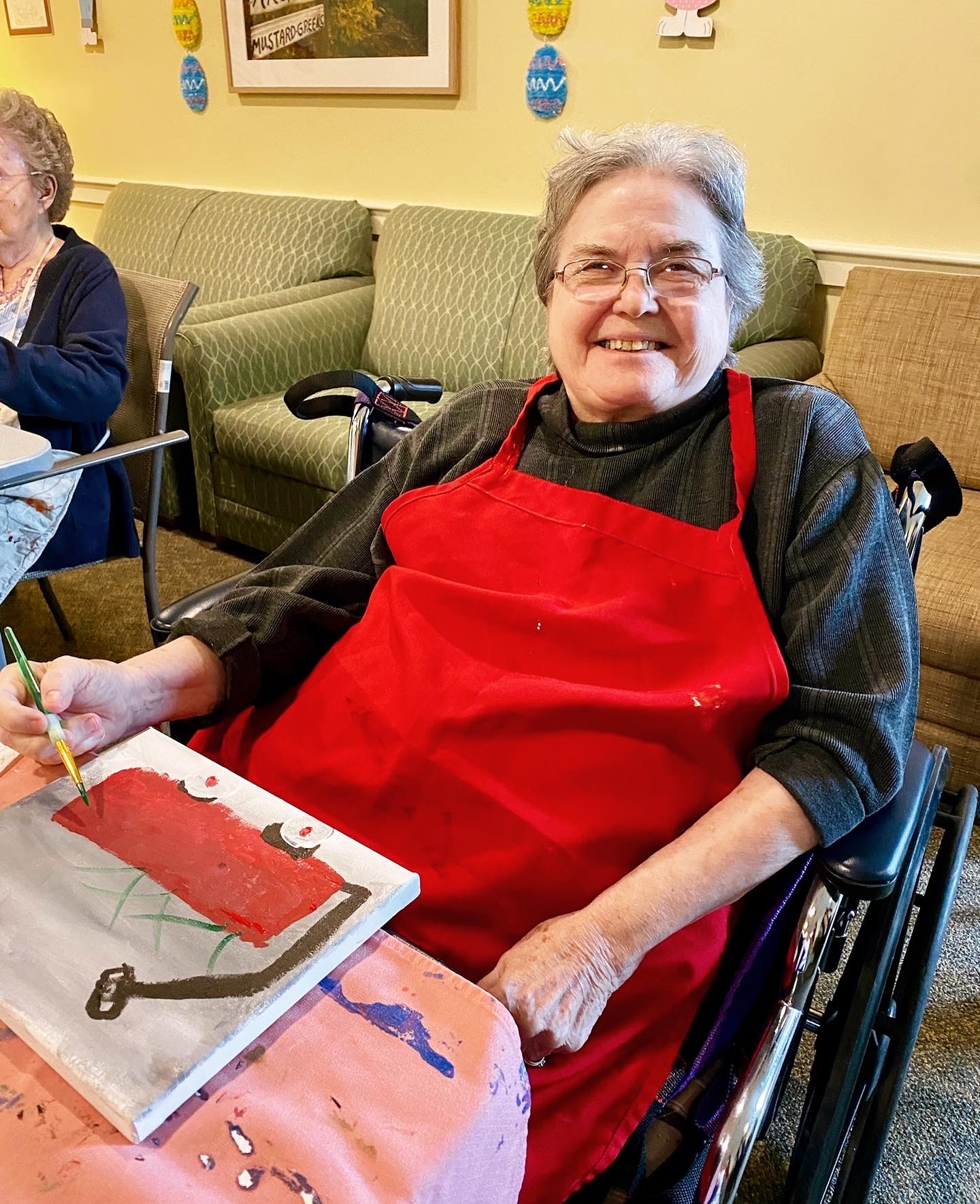 Resident enjoying an art activity in a common area