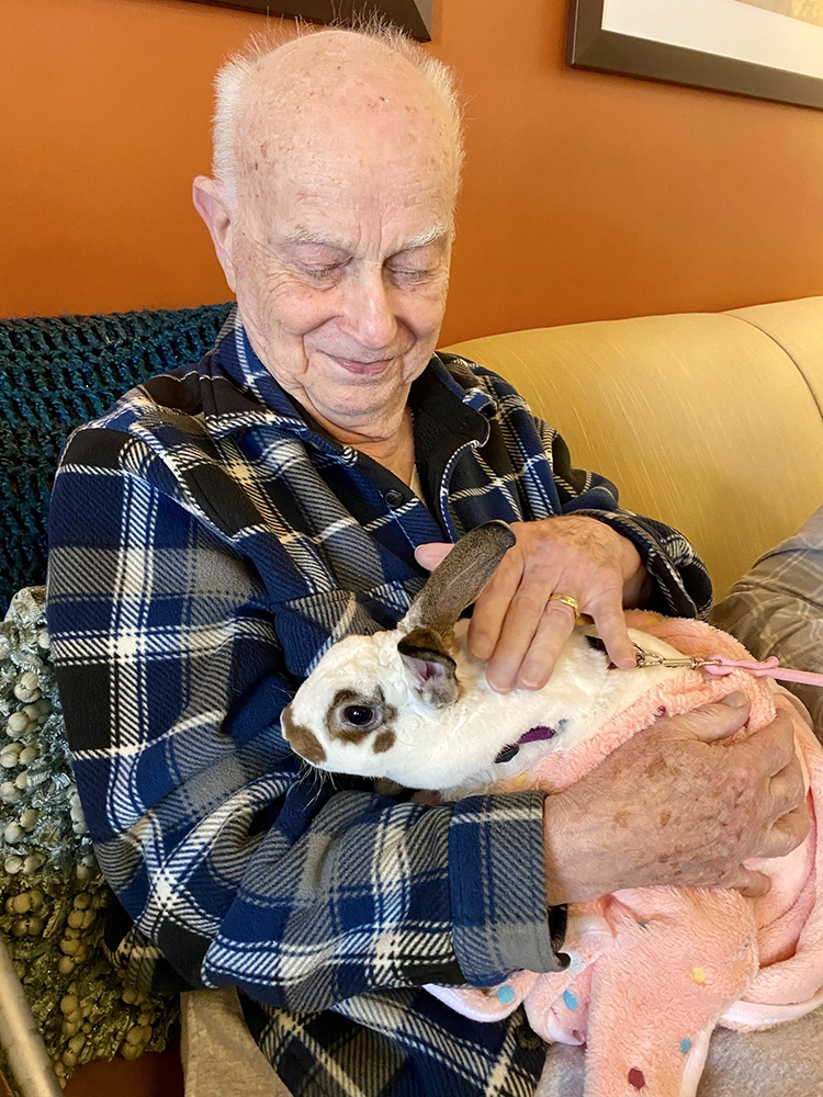 Resident with a rabbit in their lap