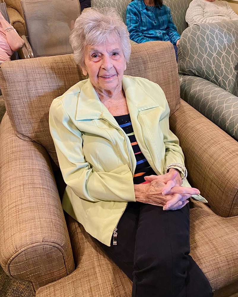 Resident seated in a common area chair