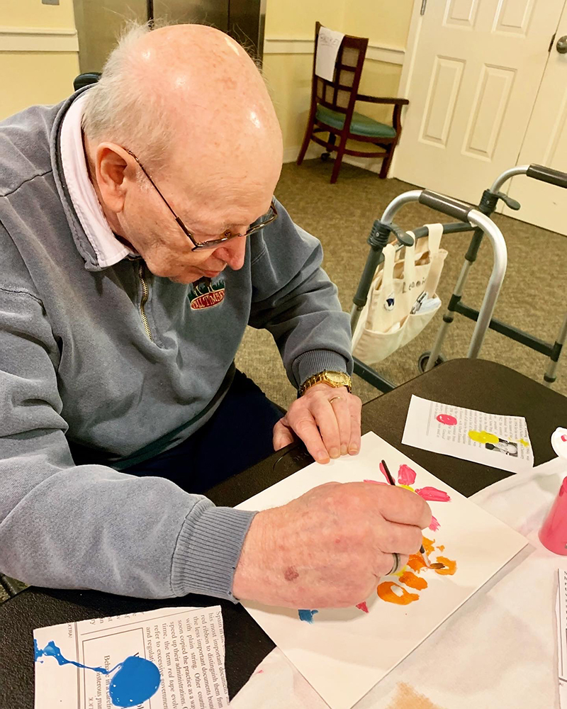 Resident painting during an art activity