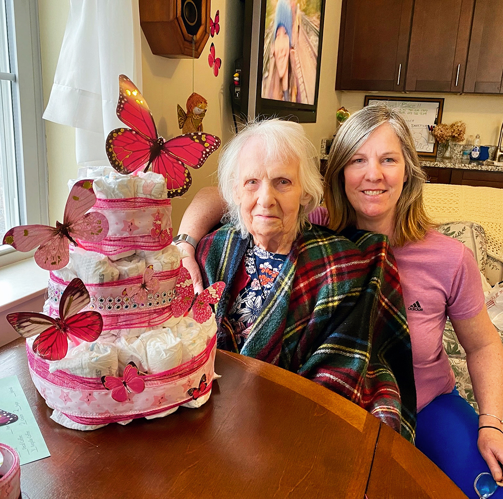Resident and staff member celebrating with cupcakes