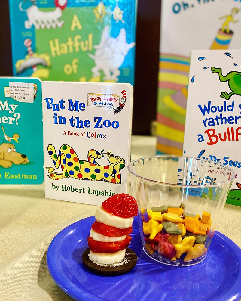 Assorted children's books with snack plate