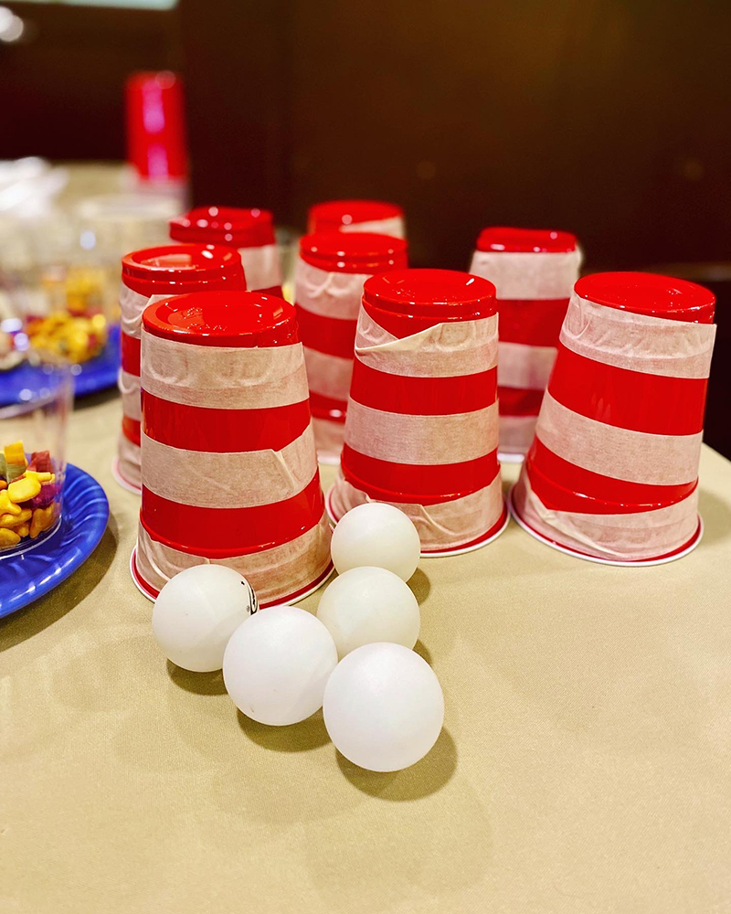 Red cups and white balls on a table