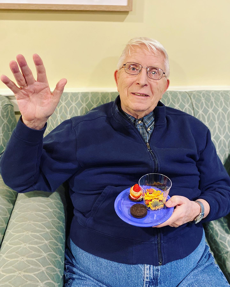 Resident enjoying snacks in a cozy common area