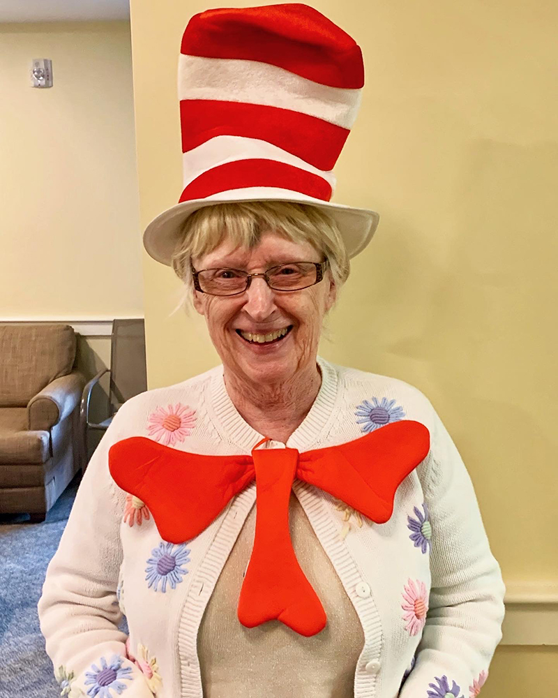 Resident wearing a whimsical hat and bow tie