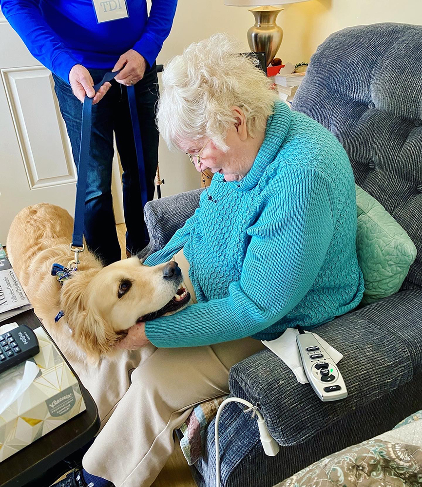 Resident interacting with a therapy dog