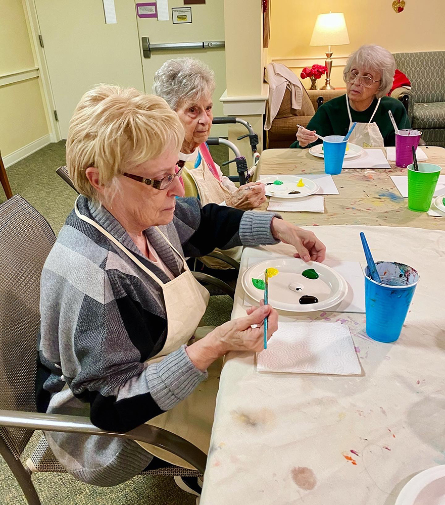 Residents painting in a common activity room