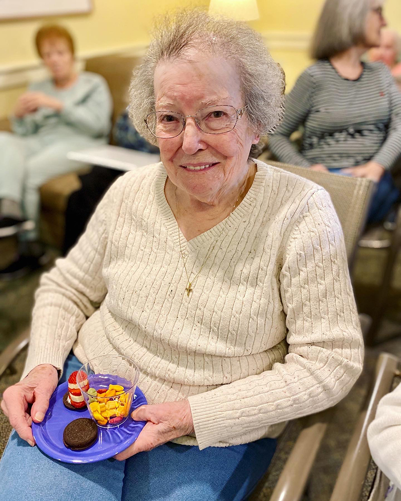A resident holding snacks in a common area