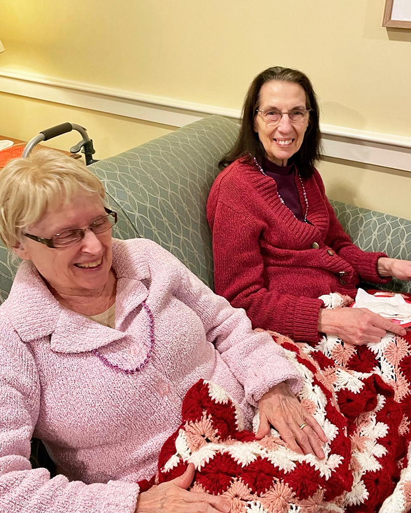Two smiling residents enjoying their time indoors