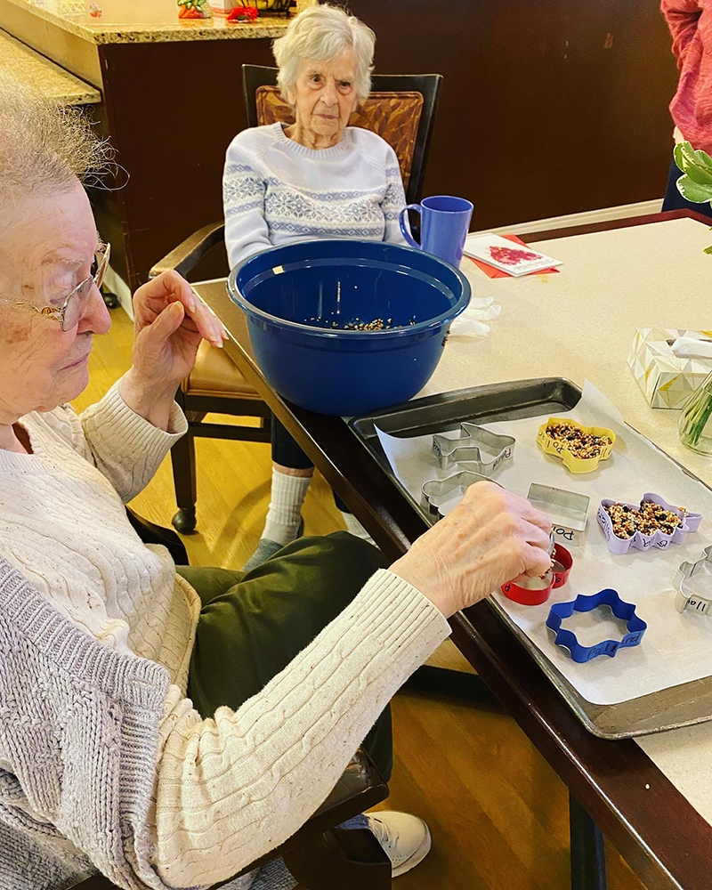 Residents participating in an activity at a dining table