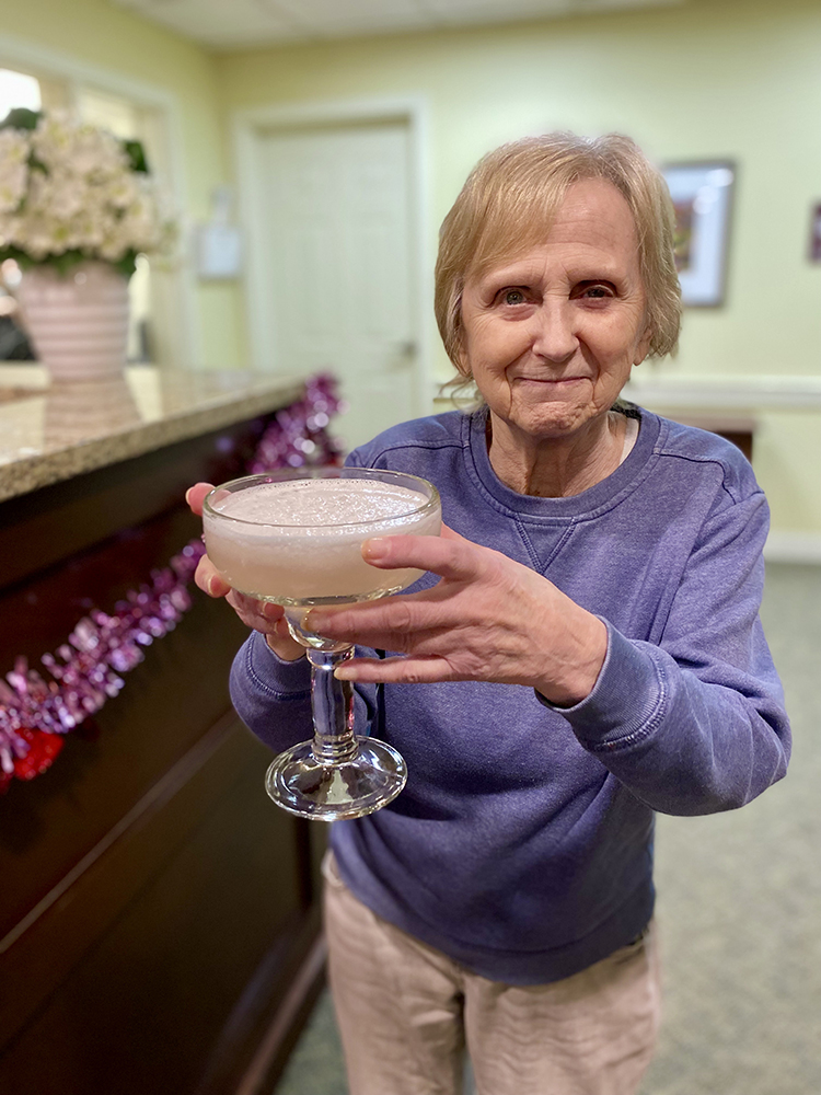 Resident celebrating with a large drink at the facility