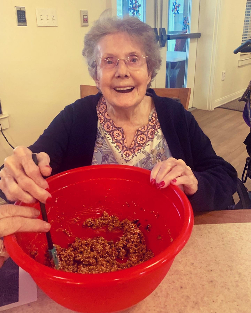 Senior resident mixing ingredients in a large bowl