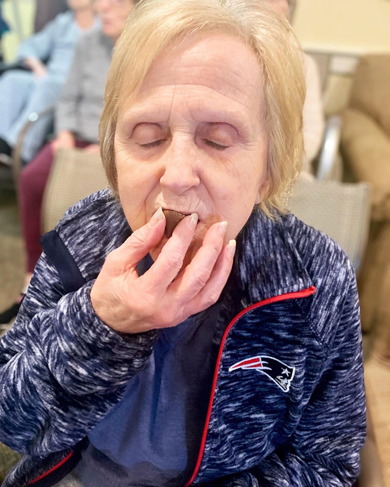 Resident enjoying a chocolate treat in an activity room