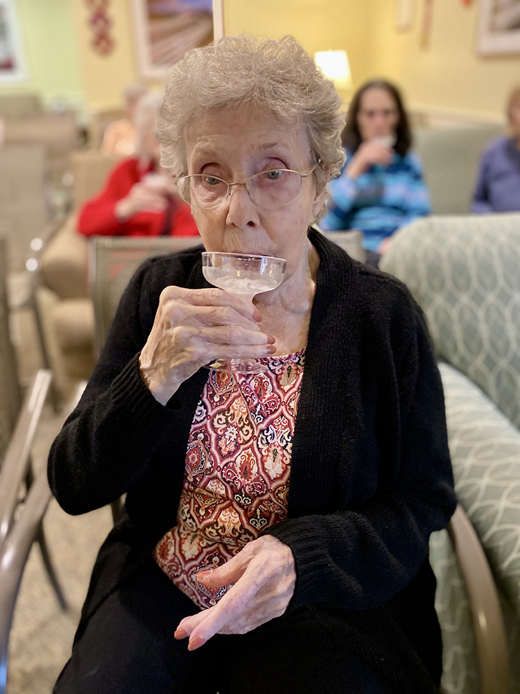 Resident enjoying a drink in a social setting