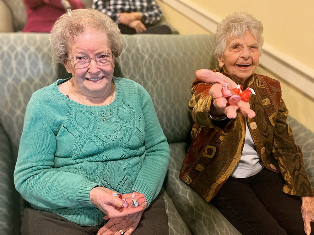 Two residents enjoying an activity with colorful items.
