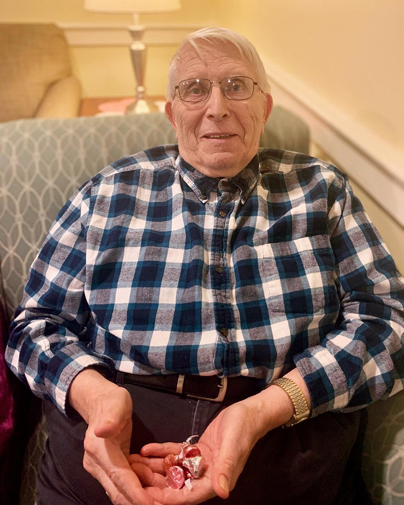 A resident holding candy in a cozy indoor space