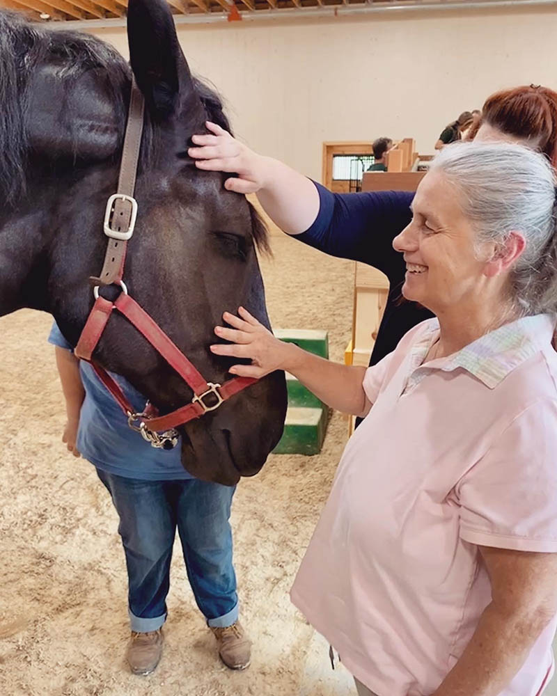 Resident interacting with a therapy horse indoors