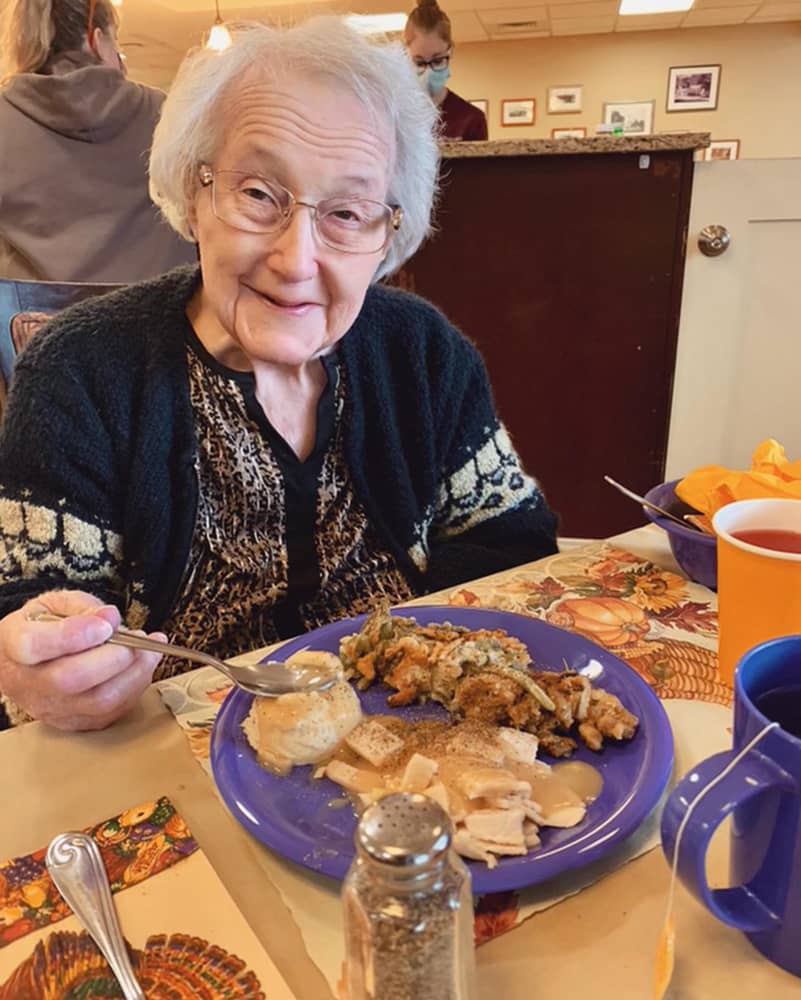 Resident enjoying a meal in the dining room