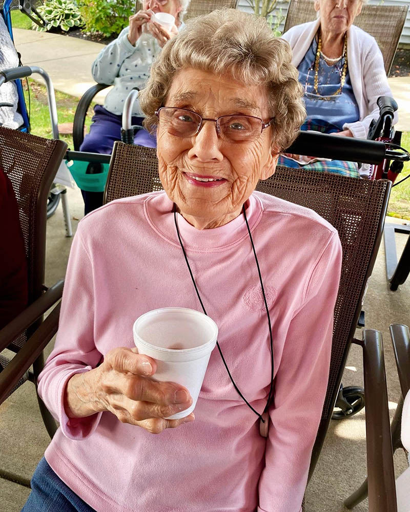 Resident enjoying a drink in an outdoor space