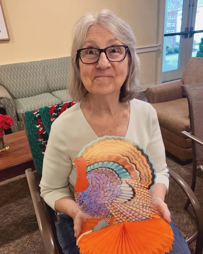 Resident enjoying a Thanksgiving craft activity
