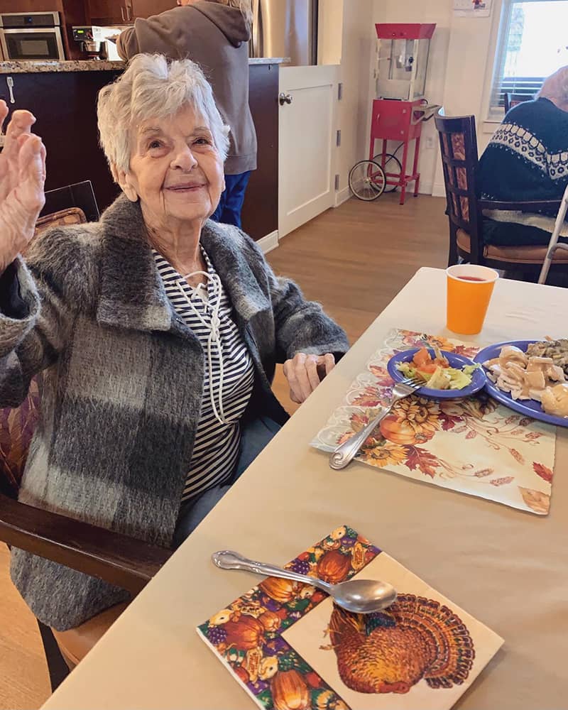 A resident enjoying a meal in the dining area