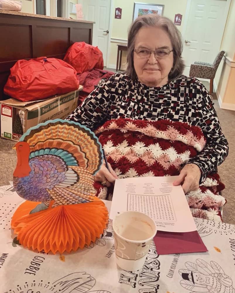 Resident engaging in a holiday activity with decorations
