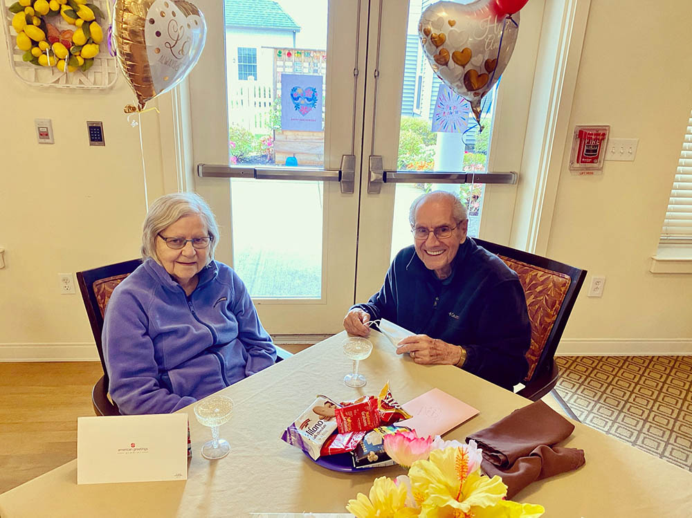 Residents enjoying snacks and celebration indoors