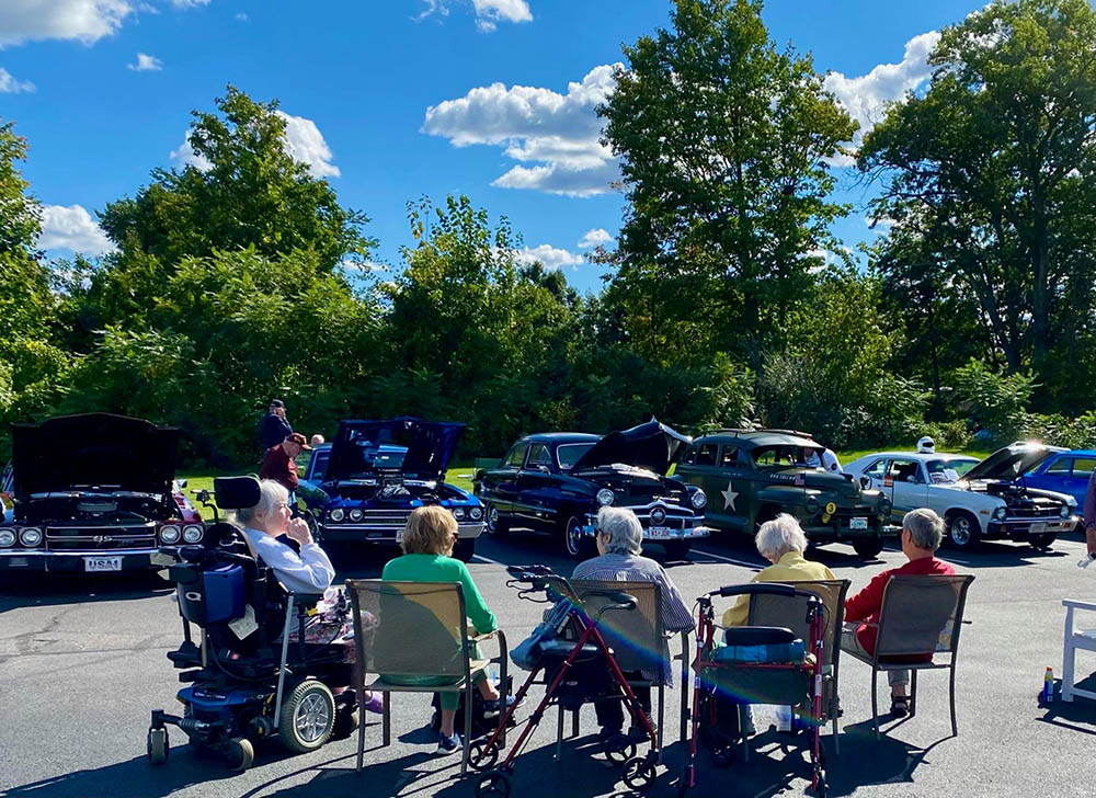 Residents enjoying a classic car show outdoors