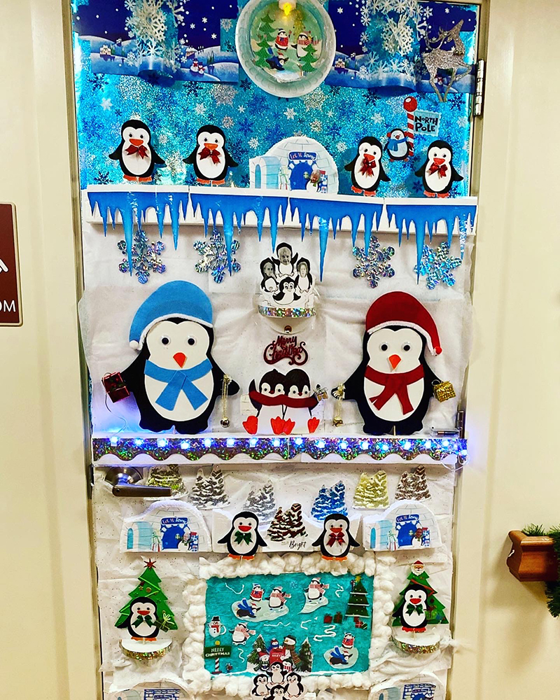 Decorated door with penguin-themed holiday display