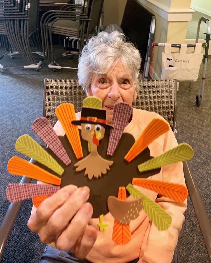 Resident proudly displays a festive turkey craft