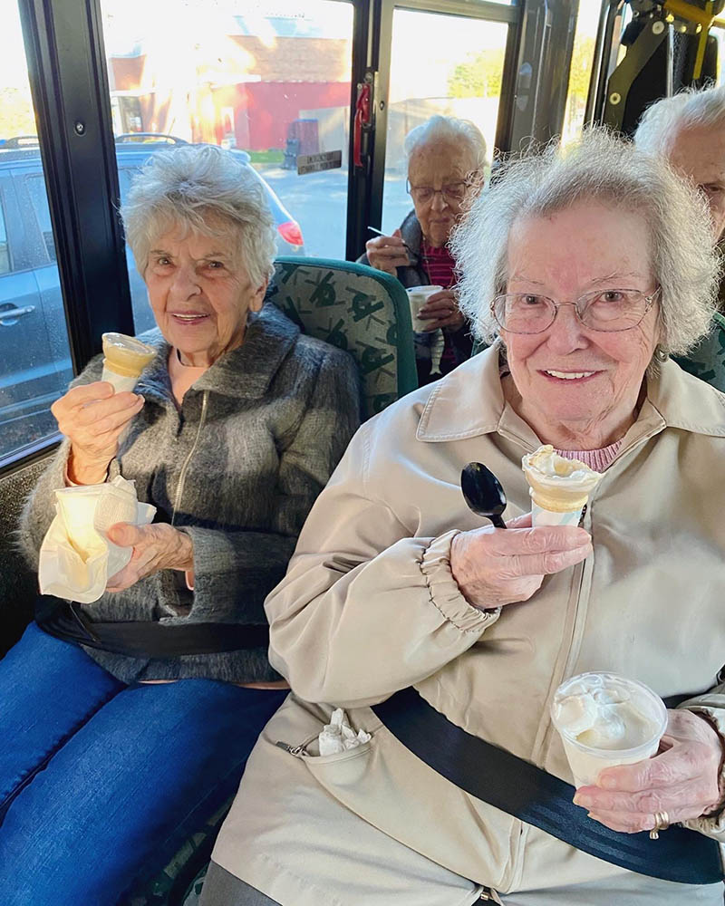 Residents enjoying ice cream on a bus outing