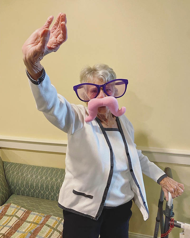 Resident participating in a fun activity with props