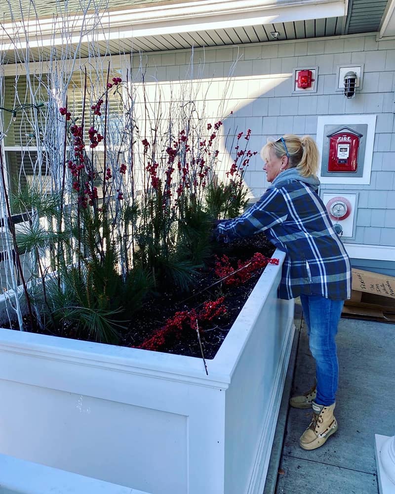 A staff member gardening at an assisted living facility