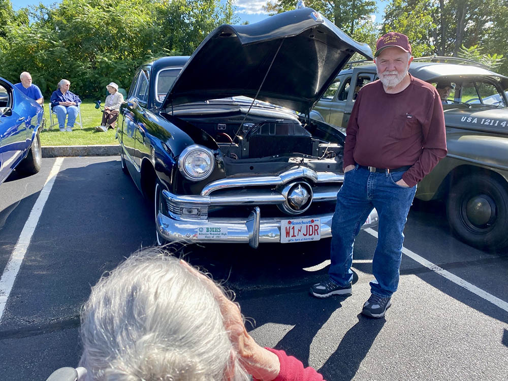 Residents enjoying a classic car show in the facility parking lot