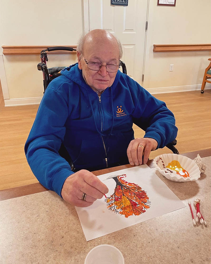 Resident creating art during an indoor activity