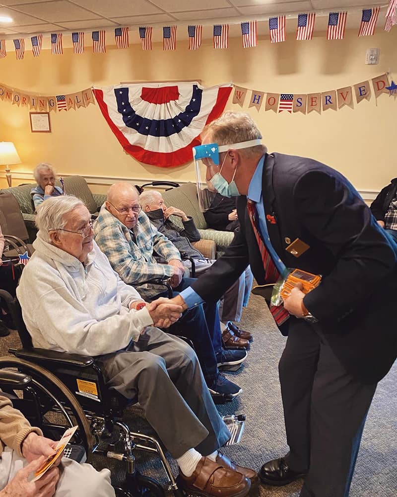 Residents engaging with a visitor in a common area