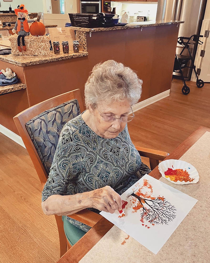 Resident painting in an activity area