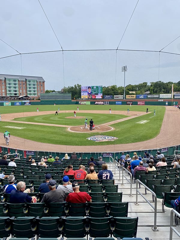 People enjoying a baseball game in a stadium