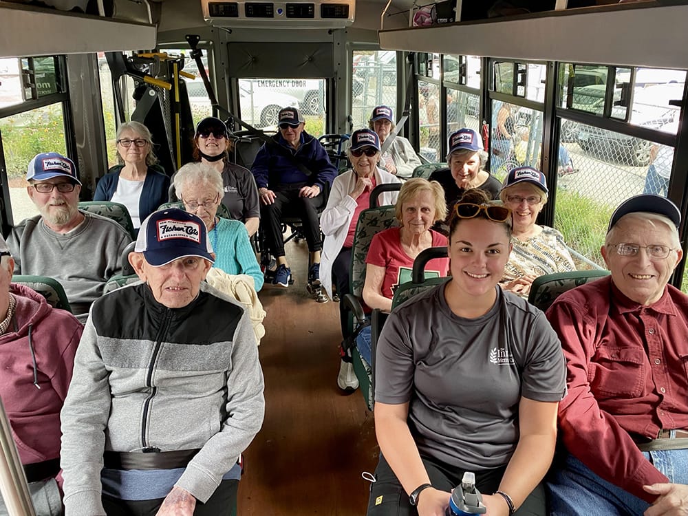 Residents and staff on a facility transport vehicle