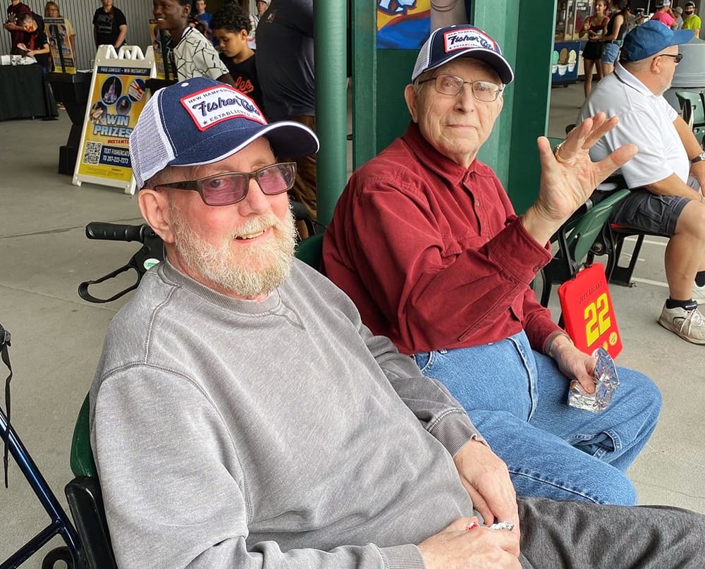 Two senior men enjoying a day at an outdoor event
