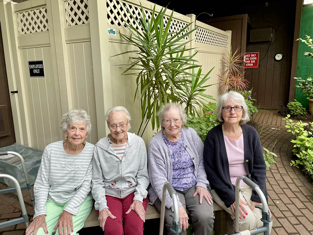 Four female residents enjoying time together outdoors