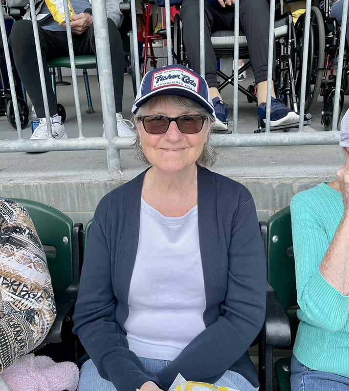 Resident enjoying an outdoor event at the facility
