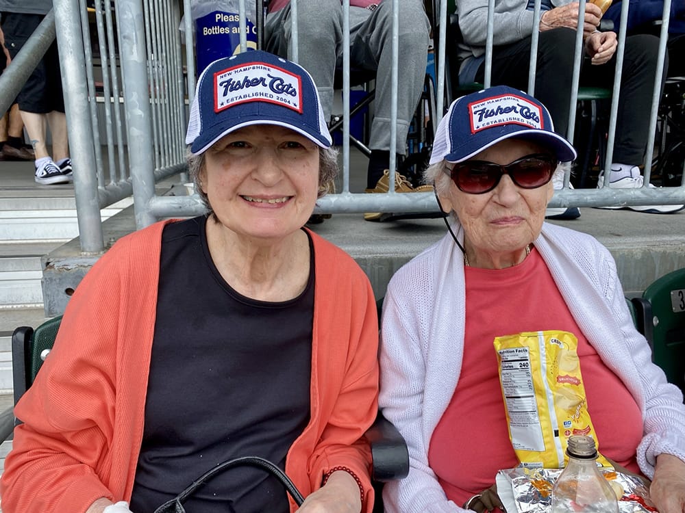 Two residents enjoying snacks at an outdoor event