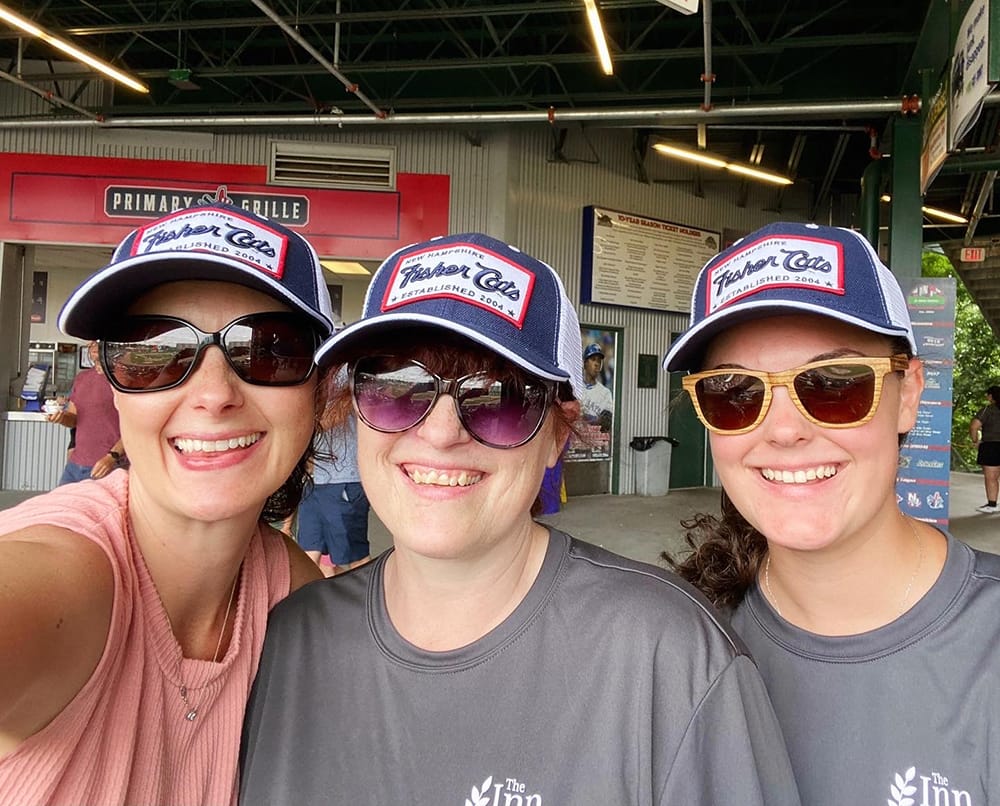Three staff members smiling at an event