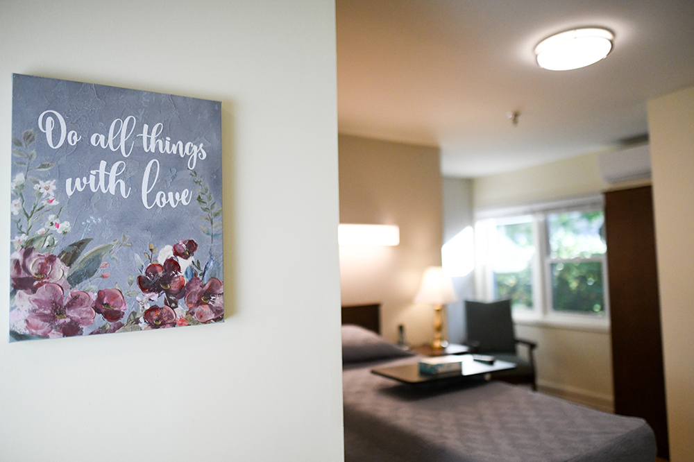 A cozy resident room with a motivational wall art