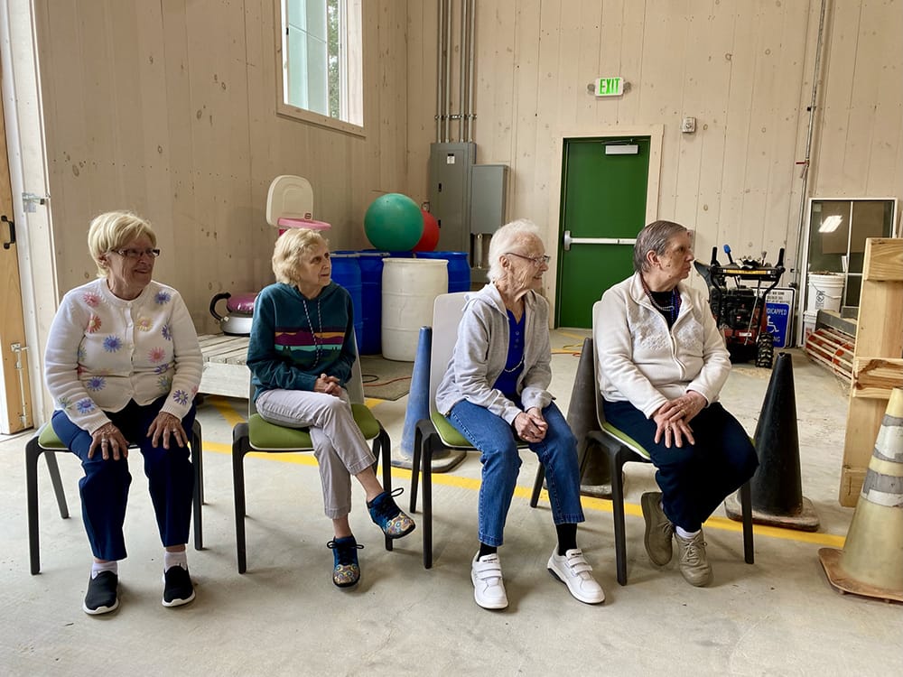 Residents sitting in a recreational area, engaging socially