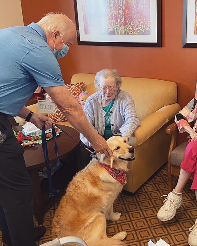 Residents interacting with a therapy dog