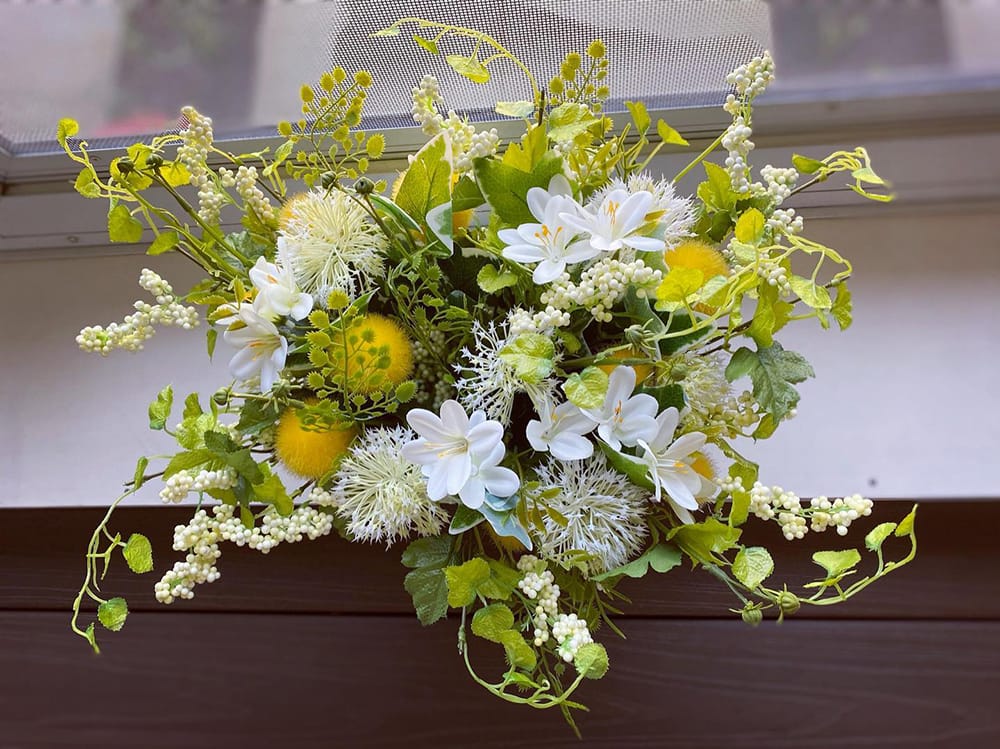 Artificial floral arrangement on a windowsill